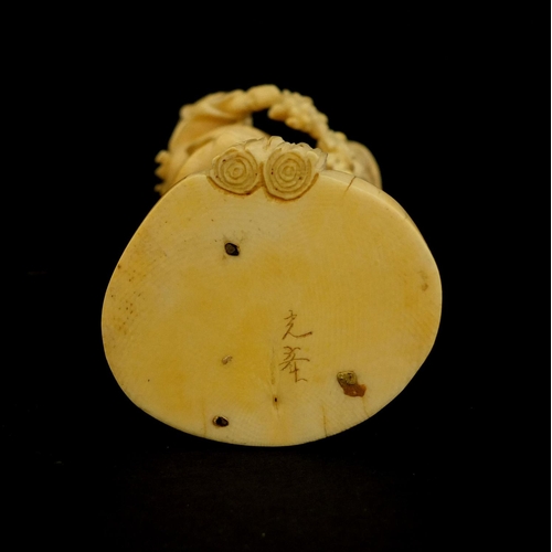 457 - Japanese carved ivory okimono of a mother holding her baby and grapes, character marks to the base, ... 