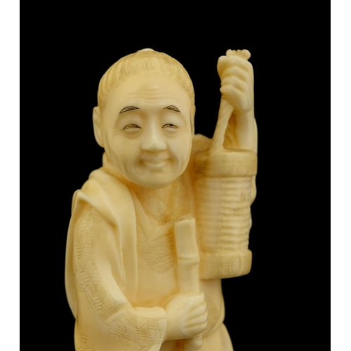 460 - Japanese carved ivory okimono of a man holding a bucket and rake, character marks to the base, 15.5c... 