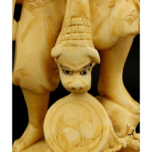 459 - Japanese carved ivory okimono of a man and monkey, red inset character marks to the base, 19.5cm hig... 