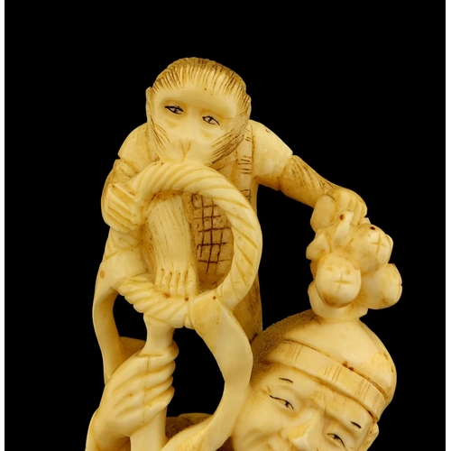 459 - Japanese carved ivory okimono of a man and monkey, red inset character marks to the base, 19.5cm hig... 