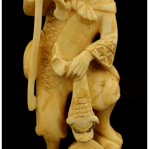 459 - Japanese carved ivory okimono of a man and monkey, red inset character marks to the base, 19.5cm hig... 