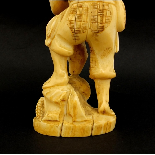 459 - Japanese carved ivory okimono of a man and monkey, red inset character marks to the base, 19.5cm hig... 