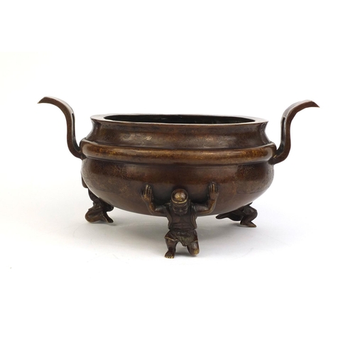 470 - Large Chinese bronze twin handled three footed censor with decorated with stylised flowers and figur... 