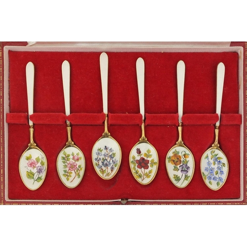 726 - Cased set of six silver gilt and enamel tea spoons, the bowls enamelled with flowers, retailed by Ha... 