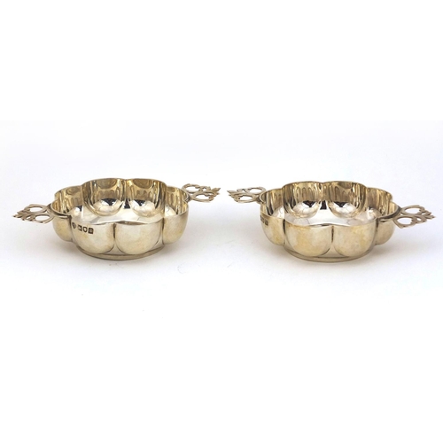 694 - Pair of Goldsmiths and Silversmiths Company silver twin handled quiaches London 1902, 13cm long, app... 