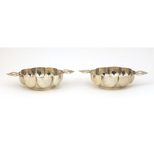 694 - Pair of Goldsmiths and Silversmiths Company silver twin handled quiaches London 1902, 13cm long, app... 