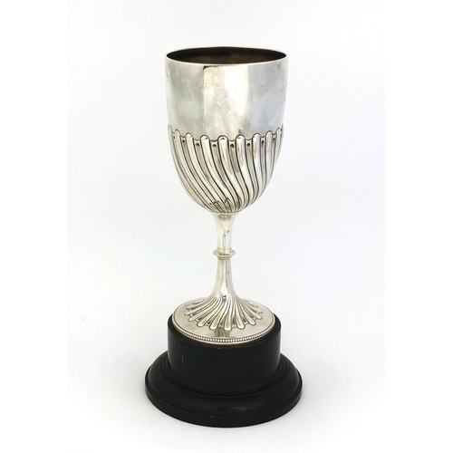 657 - Large silver trophy with demi fluted decoration, raised on a wooden base, HA Sheffield 1894, 22.5cm ... 