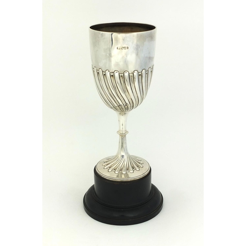 657 - Large silver trophy with demi fluted decoration, raised on a wooden base, HA Sheffield 1894, 22.5cm ... 