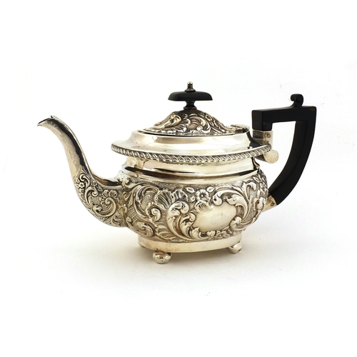 682 - Silver teapot, profusely embossed floral decoration and blank cartouche, with ebonised wooden handle... 