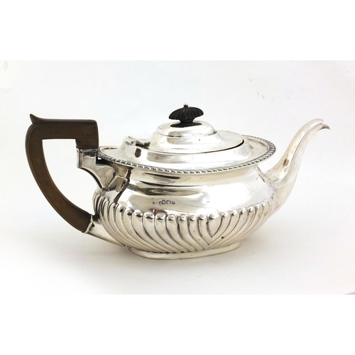 670 - Silver teapot with embossed demi fluted decoration, J.H & Co Sheffield 1900, 30cm long, approximate ... 