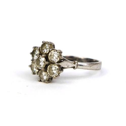 772 - 18ct white gold diamond flower head ring set with seven solitaire diamonds, size N, approximate weig... 