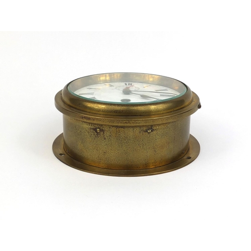 750 - Brass ships bulk head clock with enamelled dial and Roman numerals, 17cm in diameter