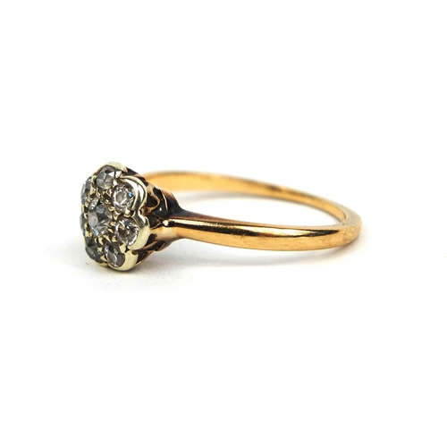 833 - Unmarked diamond flower head ring set with eight solitaire diamonds, size O, approximate weight 2.3g