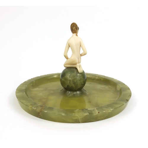630 - Art Deco carved ivory maiden sat on a green onyx centre piece, the nude maiden wearing a headdress w... 