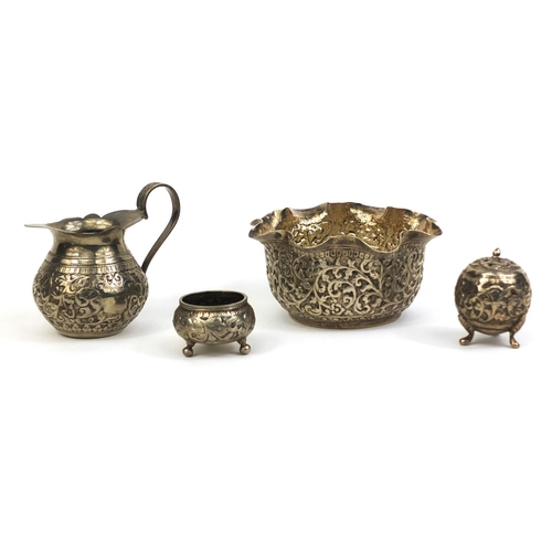 515 - Group of Middle Eastern silver coloured metal items comprising a bowl profusely embossed with foliag... 