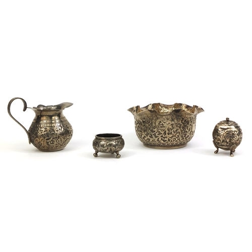 515 - Group of Middle Eastern silver coloured metal items comprising a bowl profusely embossed with foliag... 