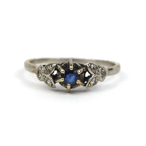 841 - Unmarked white metal sapphire and diamond ring, set with a central sapphire and six diamonds, size W... 