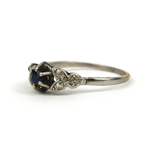 841 - Unmarked white metal sapphire and diamond ring, set with a central sapphire and six diamonds, size W... 