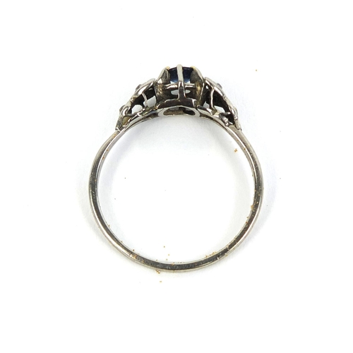 841 - Unmarked white metal sapphire and diamond ring, set with a central sapphire and six diamonds, size W... 