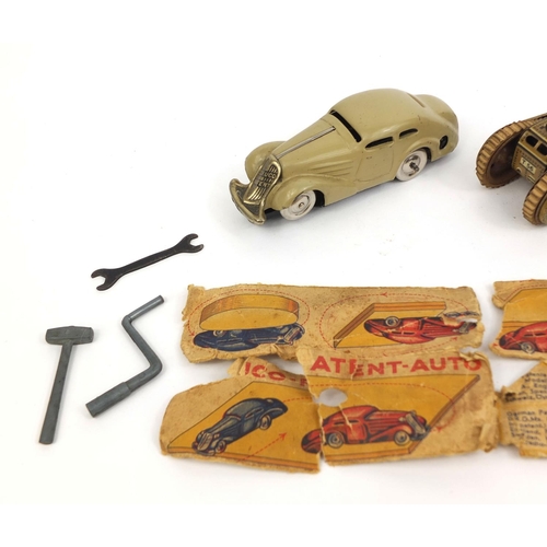 252 - Boxed Schuco tinplate model car together with a tinplate clockwork tank, the largest 11cm in length