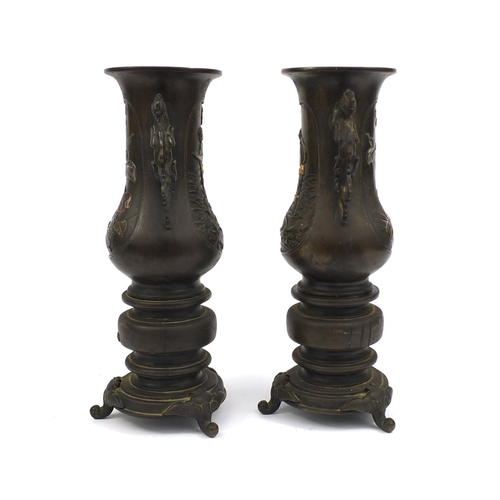 472 - Pair of Japanese bronze twin handled vases, with animalia handles, each decorated in silver with fig... 