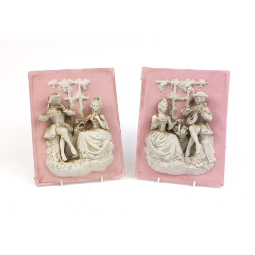 559 - Pair of continental relief moulded bisque plaques of courting couples, each 25.5cm x 19.5cm