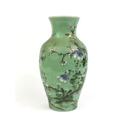 425 - Japanese porcelain vase hand painted with a bird amongst blossoming trees onto a celadon ground, six... 