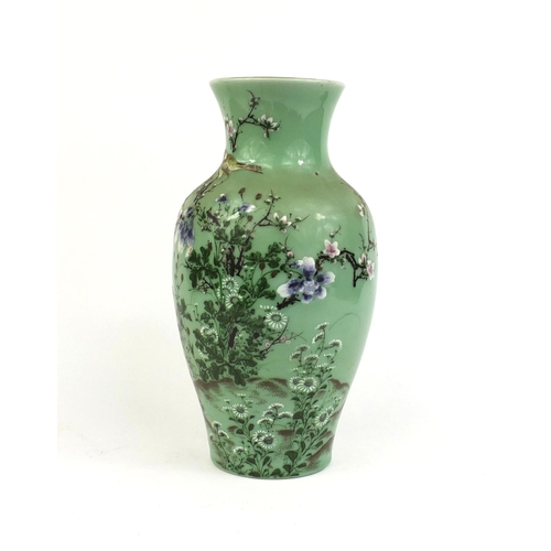 425 - Japanese porcelain vase hand painted with a bird amongst blossoming trees onto a celadon ground, six... 