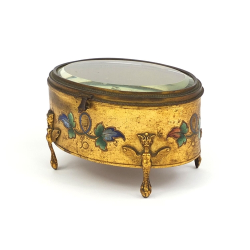 11 - Oval gilt brass and enamelled casket with bevelled glass and griffin legs, 10cm high x 16cm wide x 1... 