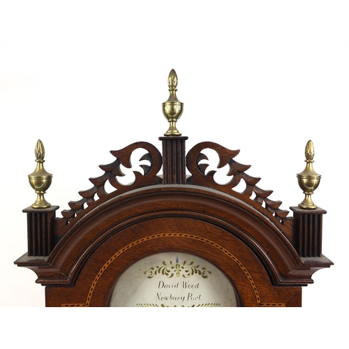 735 - Inlaid mahogany shelf clock with carved fretwork and brass urn shaped finials, the painted dial insc... 