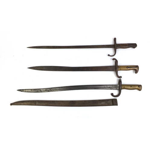 308 - Group of three Military interest bayonets including one with scabbard and one with wooden grip, each... 