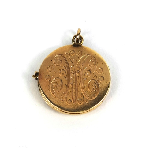 838 - 14ct gold circular locket with engine turned decoration to the back, 2.5cm in diameter, approximate ... 