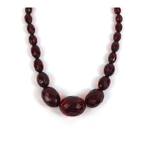 848 - Faceted cherry amber coloured bead necklace, 60cm long, approximate weight 36.5g