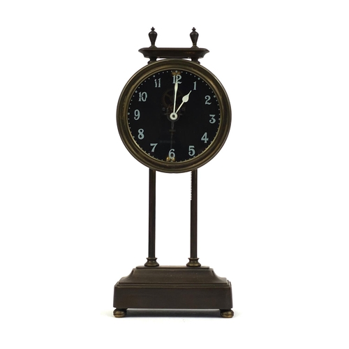 739 - Brass cased gravity clock with circular dial and Arabic Numerals, 26cm high