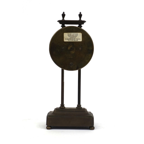 739 - Brass cased gravity clock with circular dial and Arabic Numerals, 26cm high