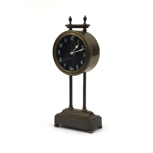 739 - Brass cased gravity clock with circular dial and Arabic Numerals, 26cm high