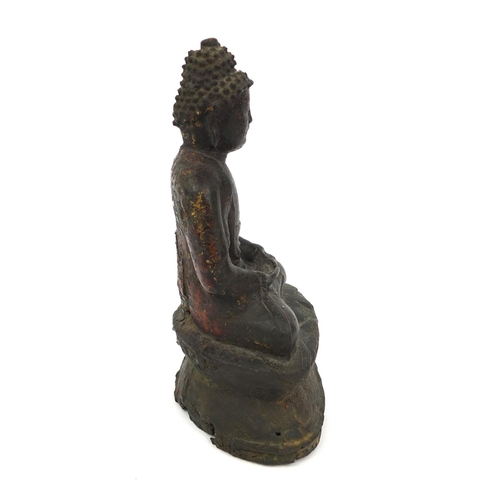 465 - Sino Tibetan bronze Buddha seated in the Lotus position, remnants of gilding and paint, 15cm high