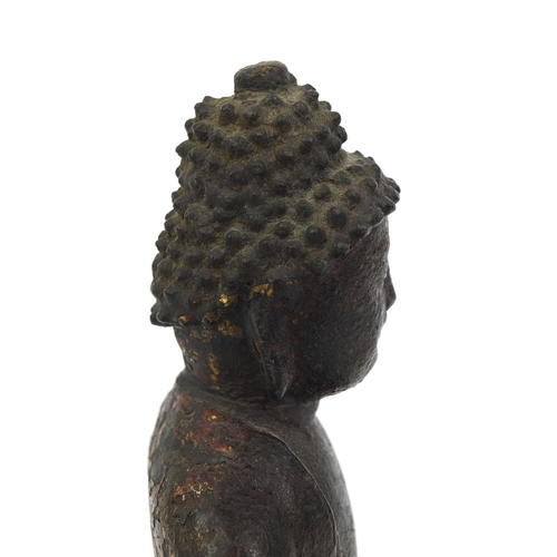 465 - Sino Tibetan bronze Buddha seated in the Lotus position, remnants of gilding and paint, 15cm high