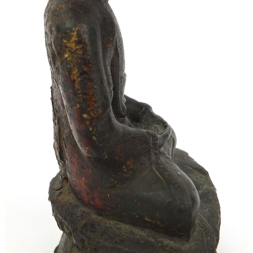 465 - Sino Tibetan bronze Buddha seated in the Lotus position, remnants of gilding and paint, 15cm high