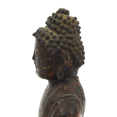 465 - Sino Tibetan bronze Buddha seated in the Lotus position, remnants of gilding and paint, 15cm high