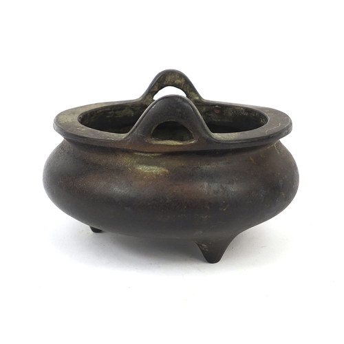 469 - Chinese bronze three footed censor twin handles, character marks to the base, 13.5cm wide