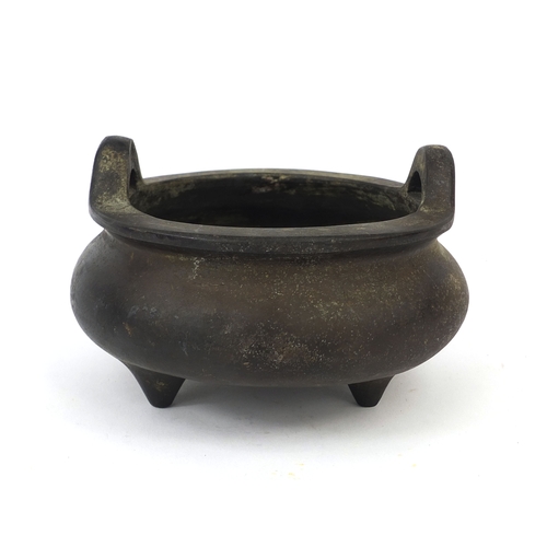 469 - Chinese bronze three footed censor twin handles, character marks to the base, 13.5cm wide