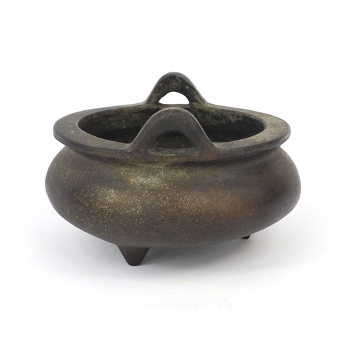 469 - Chinese bronze three footed censor twin handles, character marks to the base, 13.5cm wide