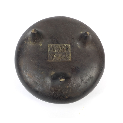 469 - Chinese bronze three footed censor twin handles, character marks to the base, 13.5cm wide