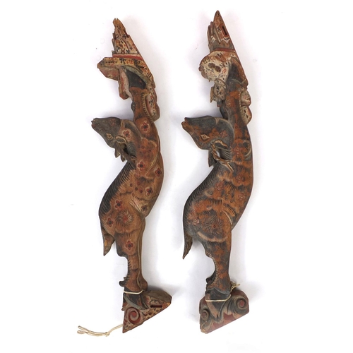 480 - Two Chinese carved wooden struts in the form of deer's, both hand painted, each 91cm high