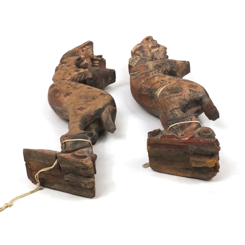 480 - Two Chinese carved wooden struts in the form of deer's, both hand painted, each 91cm high