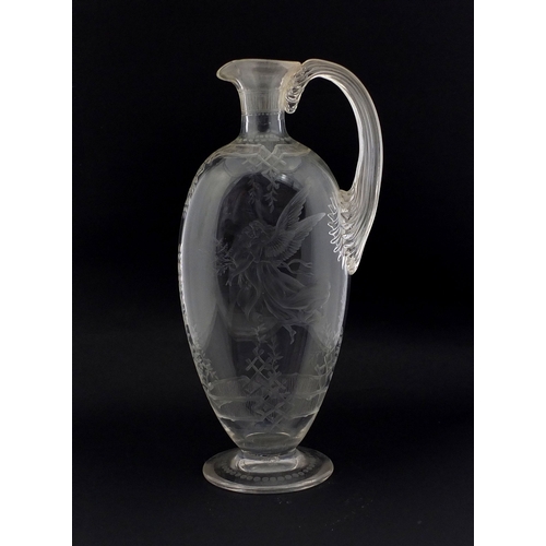 569 - 19th Century glass wine jug engraved with a guardian angel and child above a floral border, etched v... 