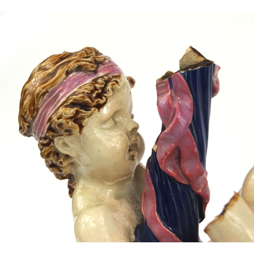 531 - Victorian Minton Majolica pottery candlestick modelled as a pair of  dancing putti with pink ribbons... 