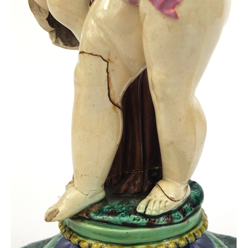 531 - Victorian Minton Majolica pottery candlestick modelled as a pair of  dancing putti with pink ribbons... 