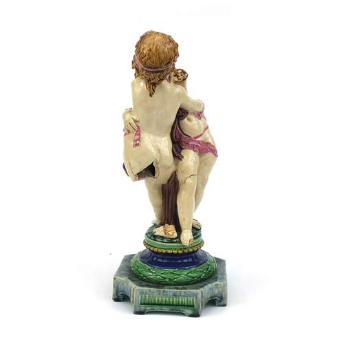 531 - Victorian Minton Majolica pottery candlestick modelled as a pair of  dancing putti with pink ribbons... 